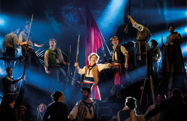 Ashley Gilmour as Enjolras and the company of Les Misérables