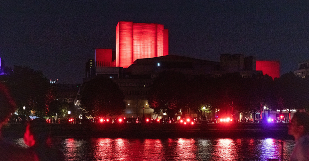 The National and the Thames lit in red