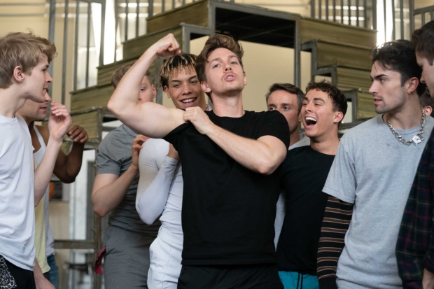 Dan Partridge (centre) and the company of Grease