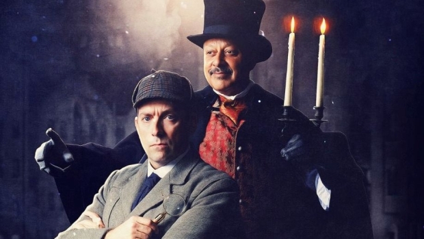 Ben Caplan (as Sherlock Holmes) and Kammy Darweish (as Ebenezer Scrooge)