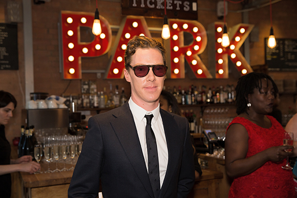 Benedict Cumberbatch protects his eyes from the glare of the Park sign